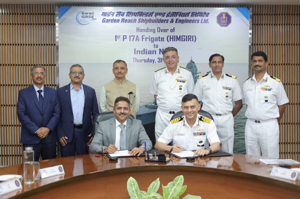 Officers Doing Paperwork while receiving INS Himgiri from GRSE