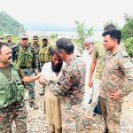 Army Officer Consoling Local
