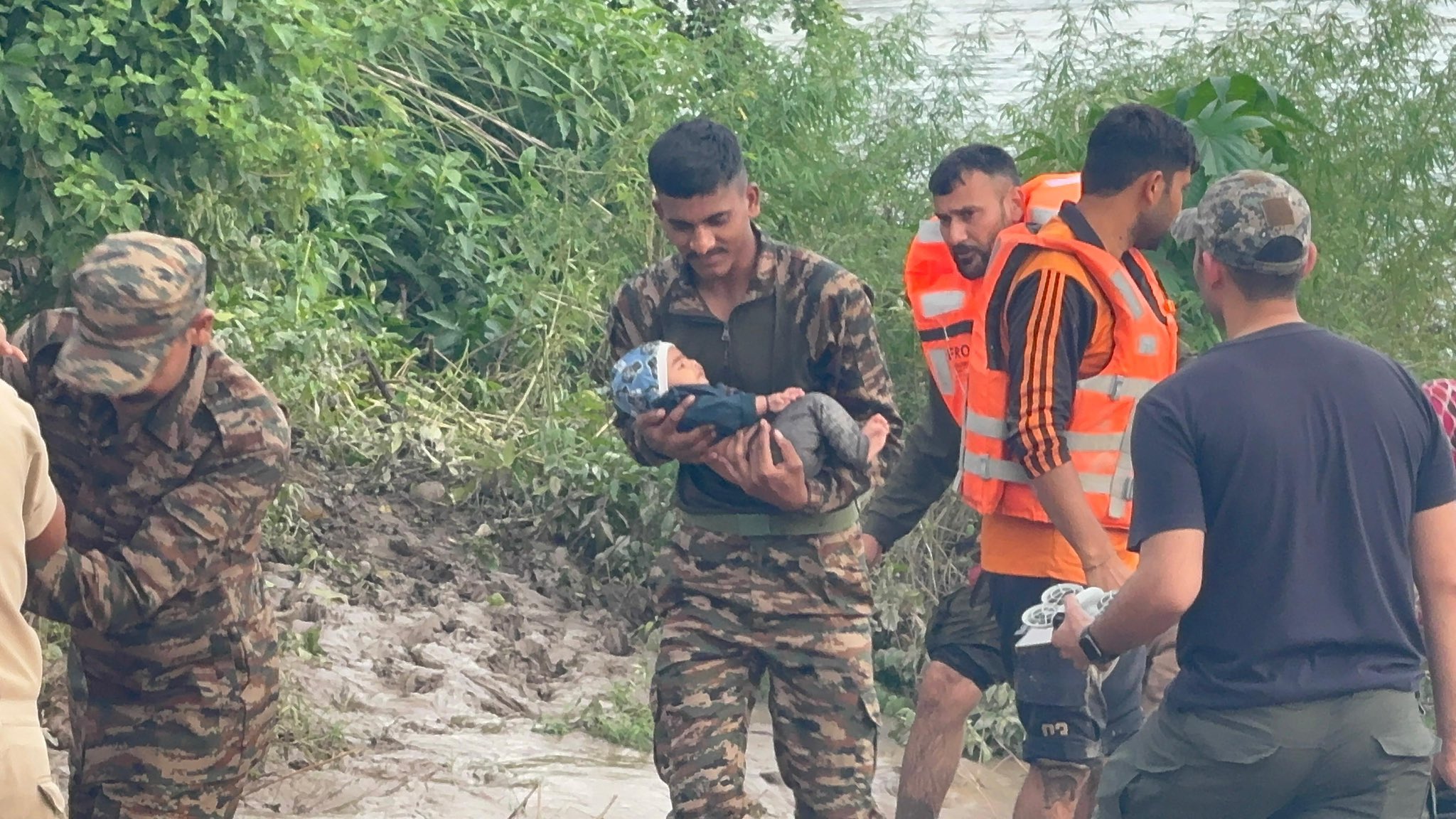 Army Personnel Saving a Child