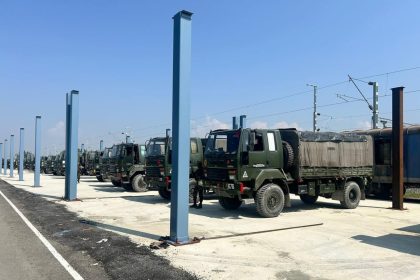 Army Trucks Along Freight Train